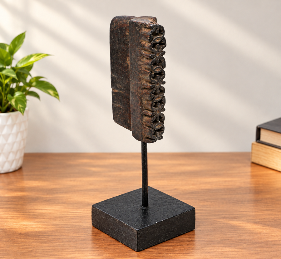 Deep-carved antique wooden textile printing block on stand, front view