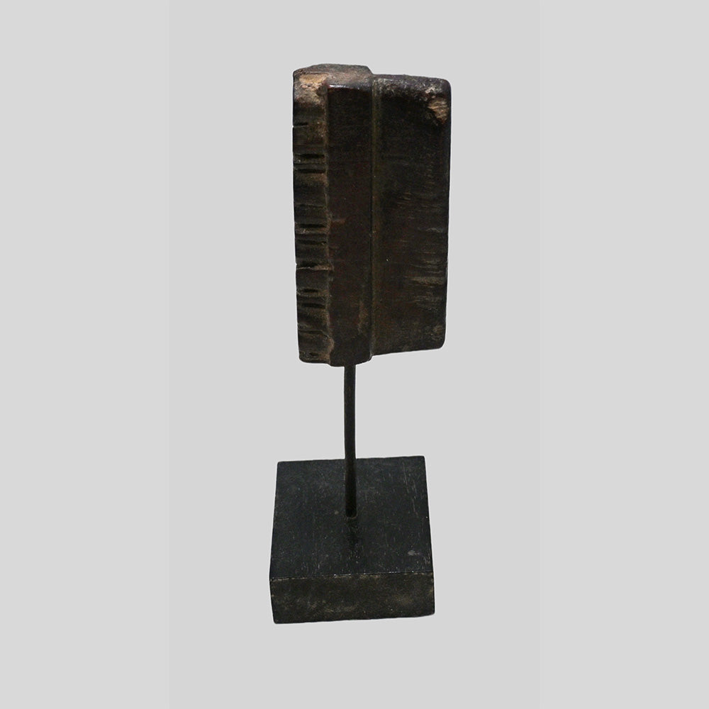 Side view of deep-carved wooden printing block and stand