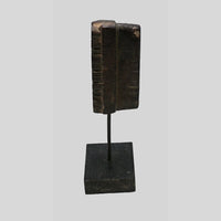 Side view of deep-carved wooden printing block and stand