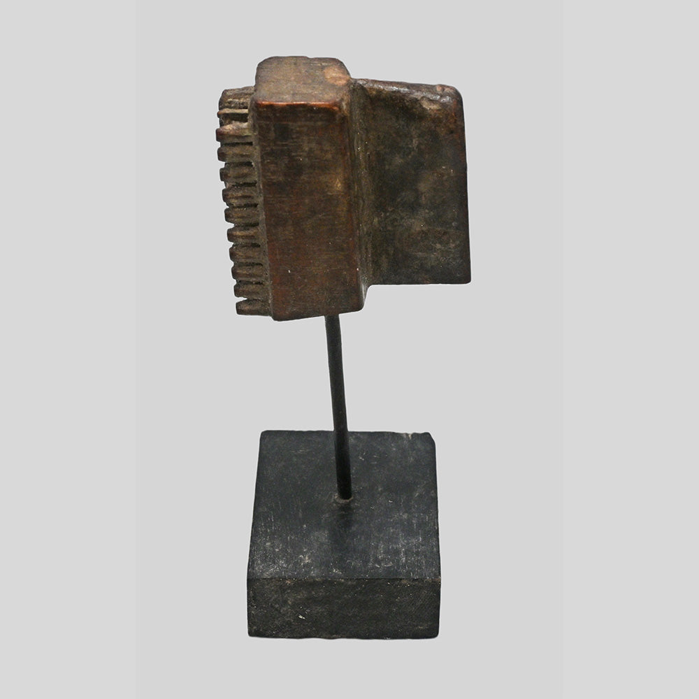 Side view of wooden textile printing block and display base