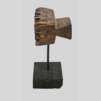 Side view of carved wooden textile printing block on stand
