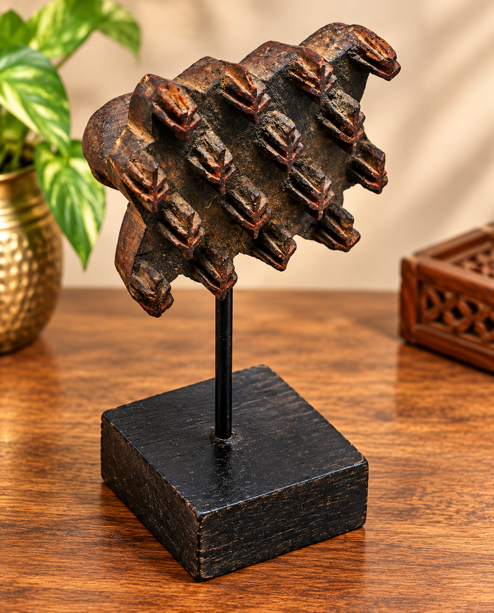 Antique wooden textile printing block with geometric floral carving on stand, front view
