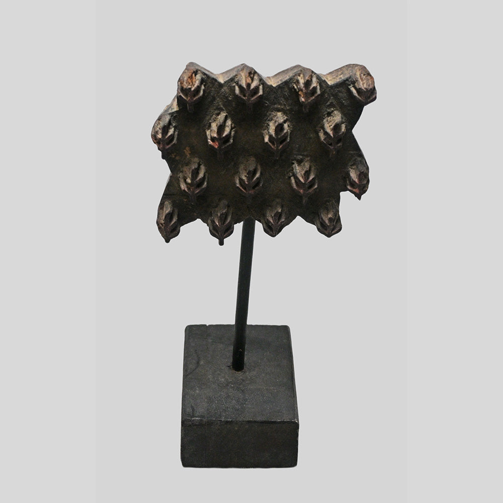 Angled view of carved geometric wooden textile printing block