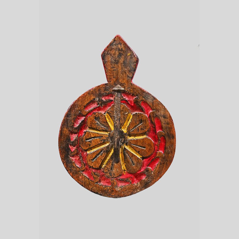 Close-up of iron hook on carved wooden key holder
