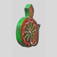 Angled view of handcrafted wooden wall key hanger with colorful floral carving