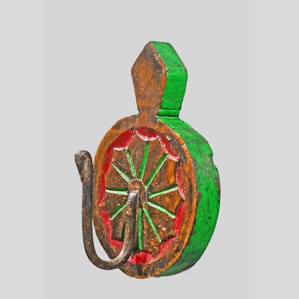 Close-up of floral sunburst carving on teak wood key holder