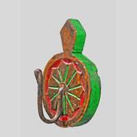 Close-up of floral sunburst carving on teak wood key holder