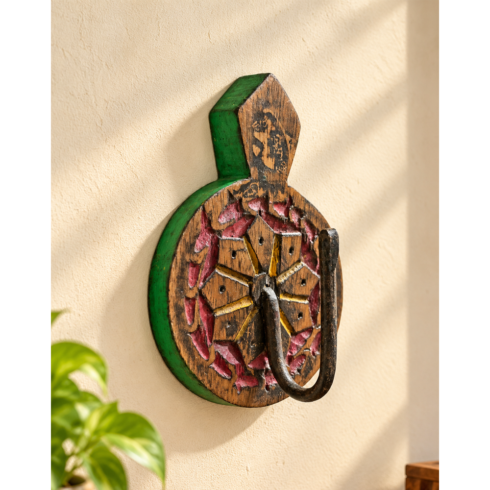 Green hand-painted wooden wall hanger with floral carving, front view