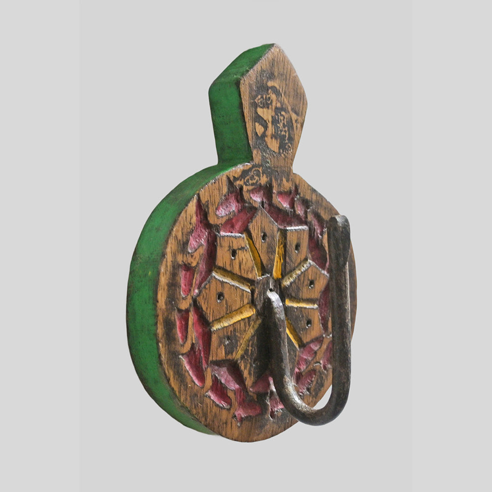 Green wooden wall hanger with iron hook, angled view