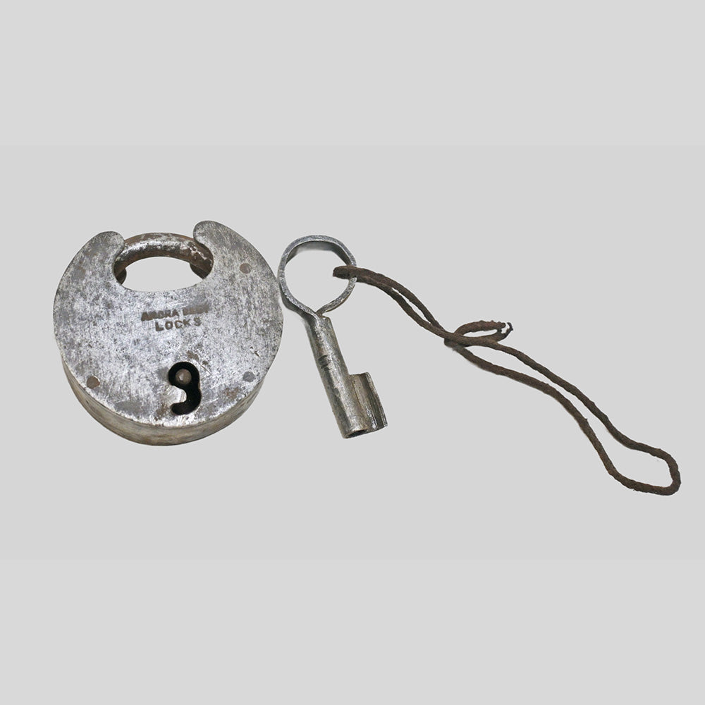 antique Aligarh-style iron padlock with key, alternate angle