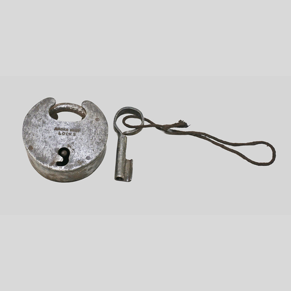 antique Aligarh-style iron padlock with key, close-up detail