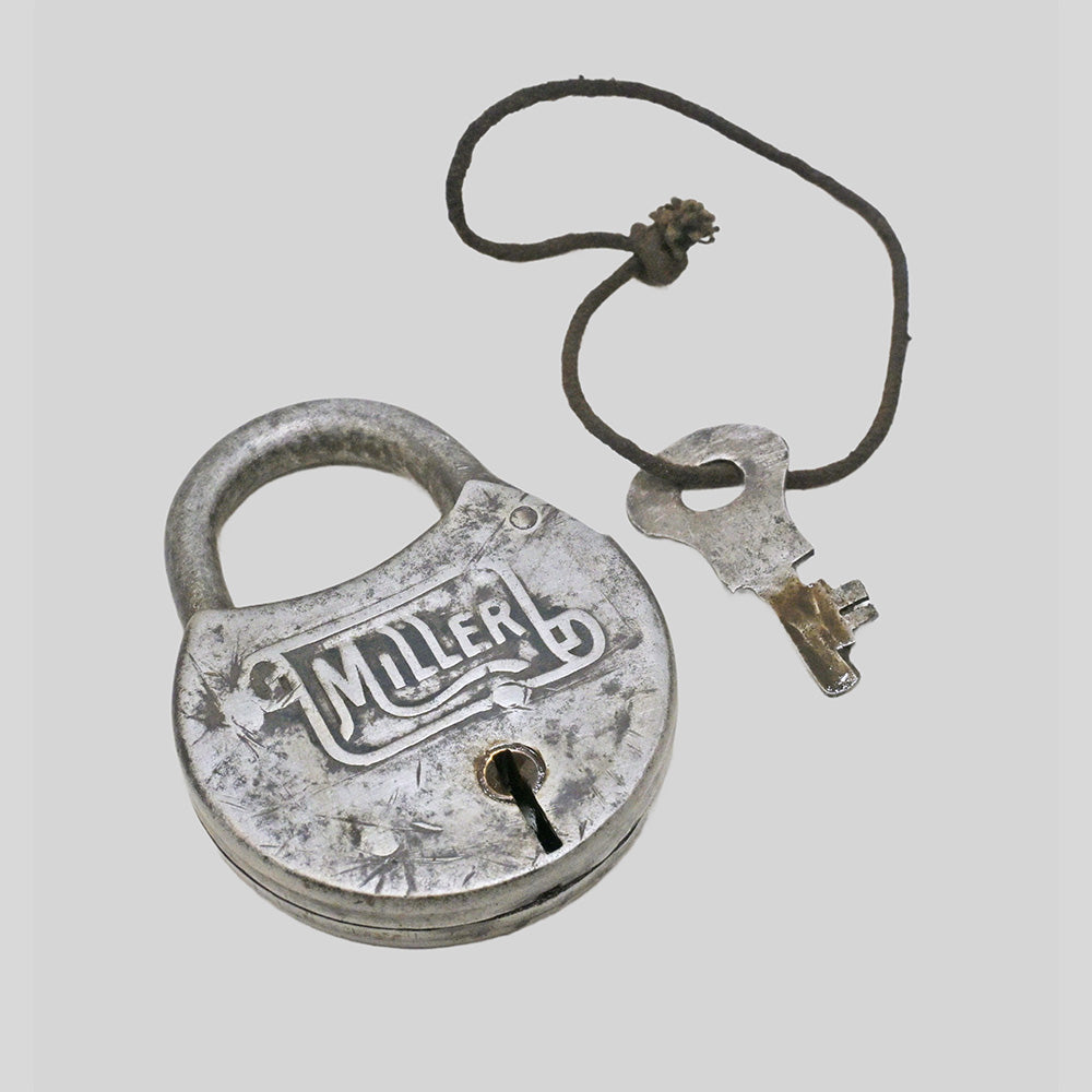 antique round iron padlock with silver finish and key, alternate angle