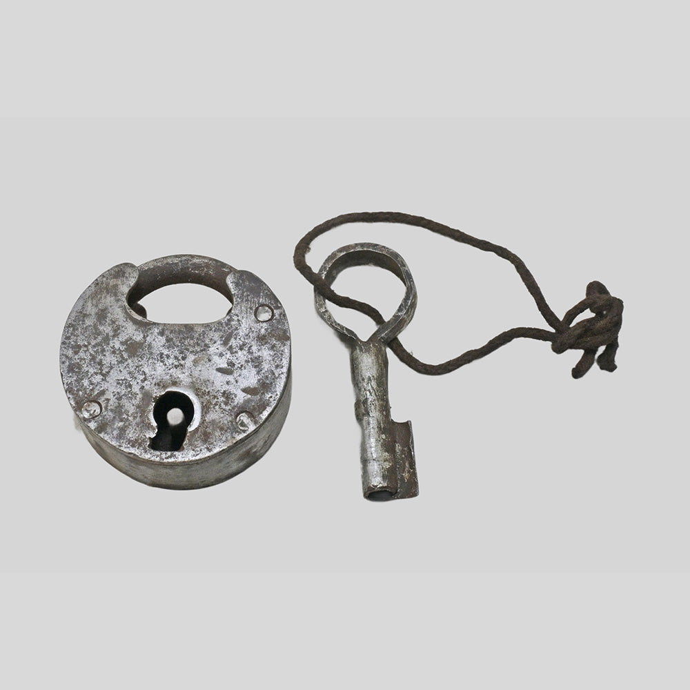 antique iron padlock with original key, close-up detail