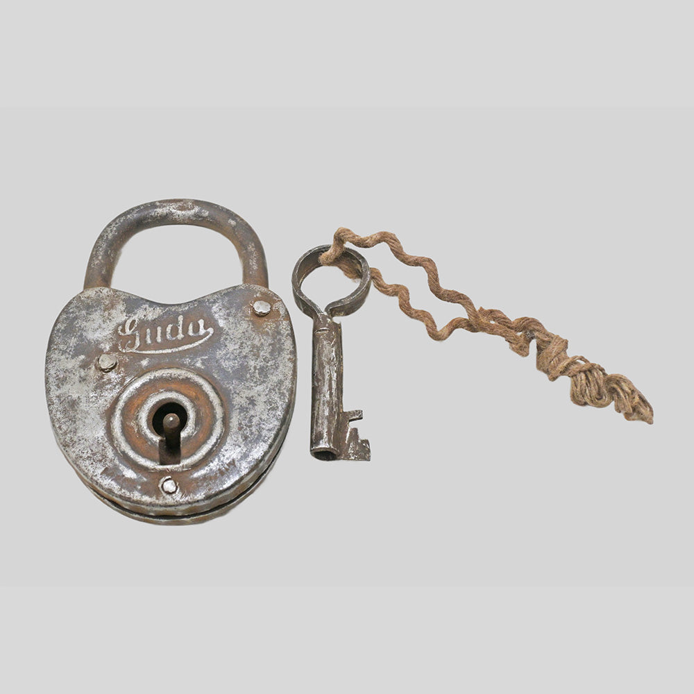 antique Aligarh iron padlock with key, close-up detail