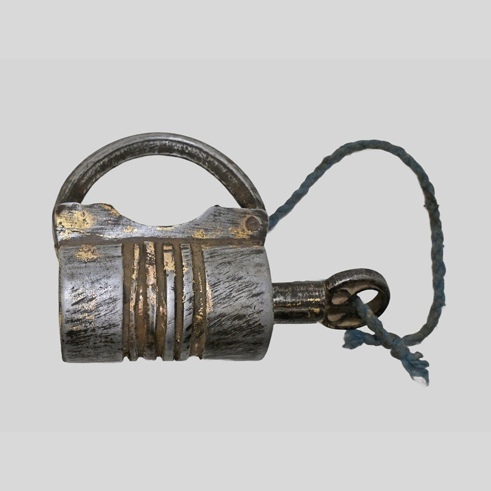 antique gold-tone ribbed metal padlock with original key, close-up detail