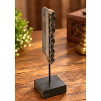 Antique wooden textile printing block on wooden stand, front view