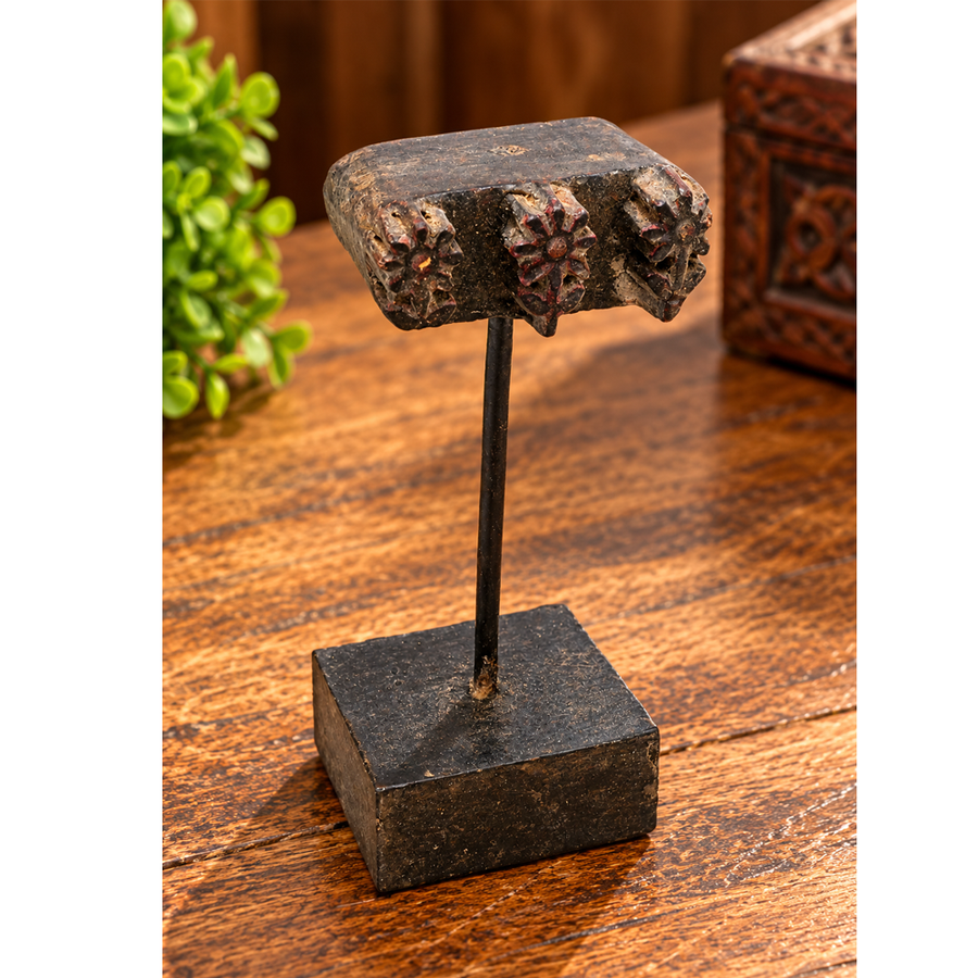 Antique wooden textile printing block on wooden stand, front view