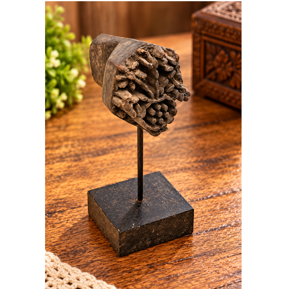 Antique wooden textile printing block on wooden stand, front view