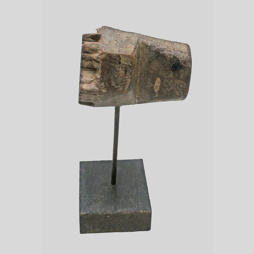 Side view of wooden printing block on stand