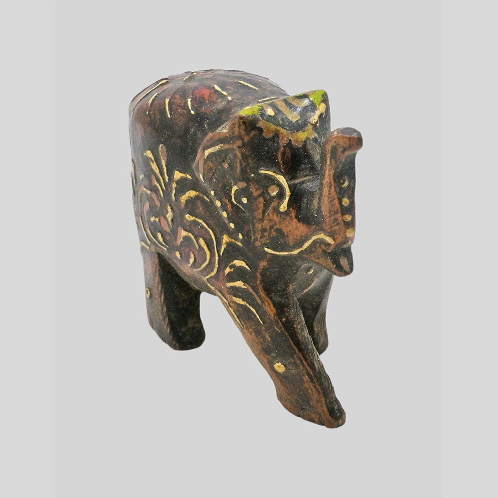 Hand-Painted Wooden Elephant Figurine with hand-painted folk-art patterns, angled view