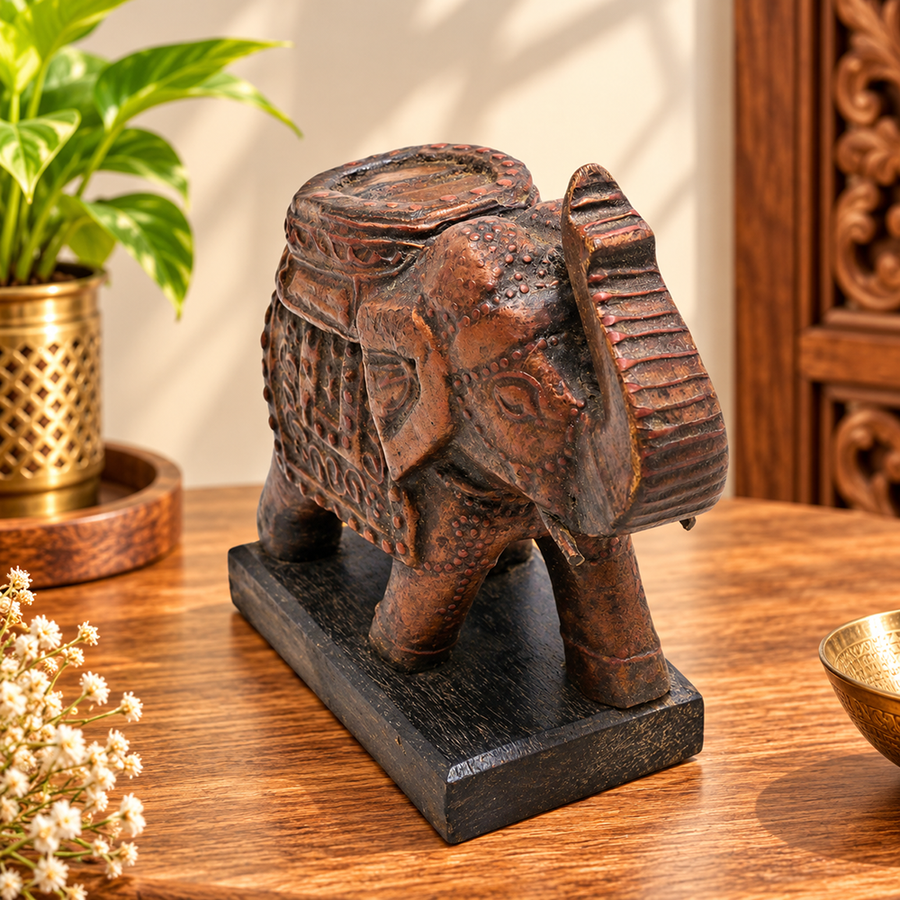 carved wooden elephant figurine with decorative motifs, front view