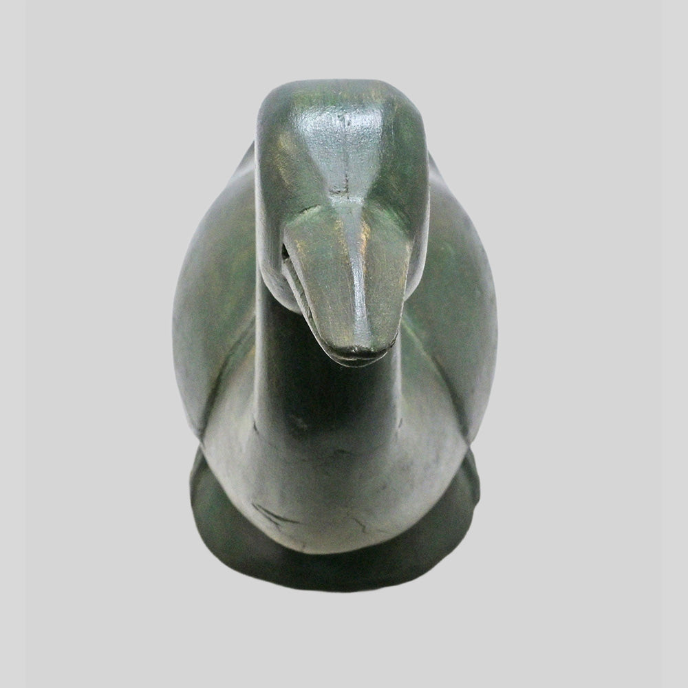 Wooden duck figurine showing sculpted beak and body