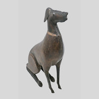 wooden and iron dog figurine, angled view