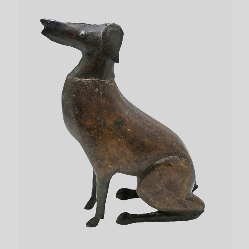 wooden and iron dog figurine, side view