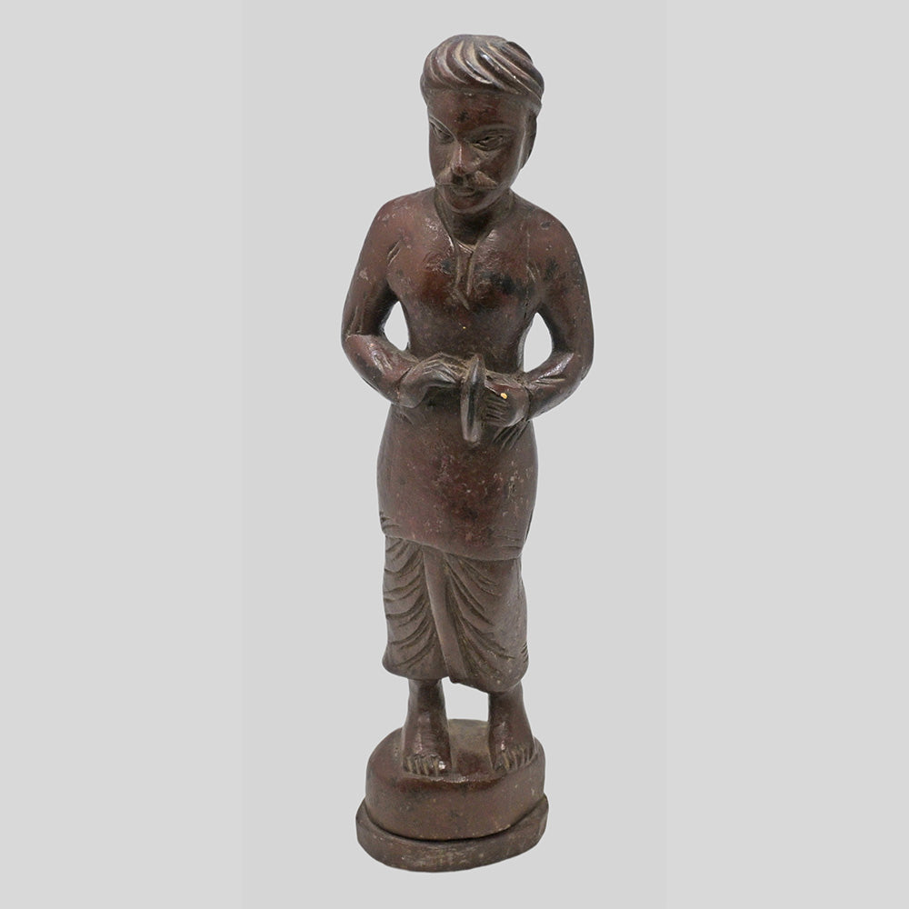 Close detail of carving on teak wood musician sculpture