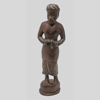 Close detail of carving on teak wood musician sculpture