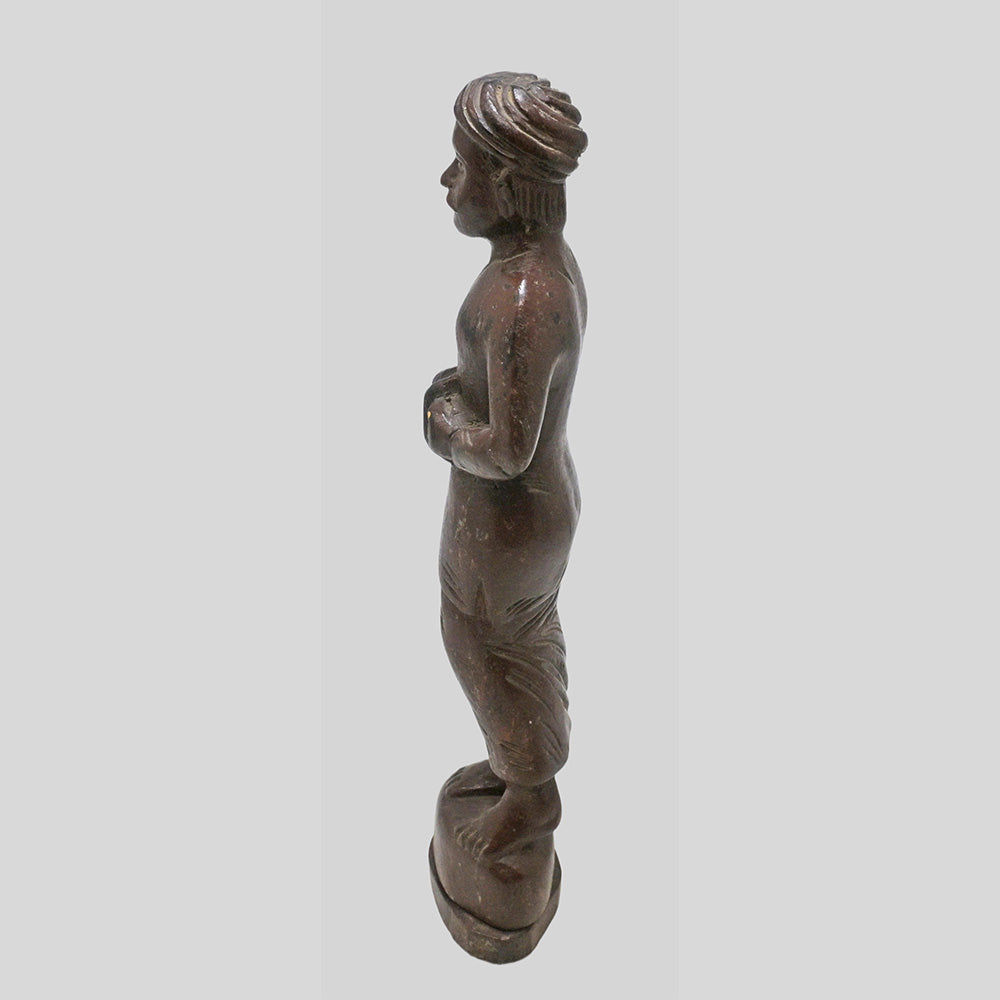 Angled view of antique Indian musician figurine