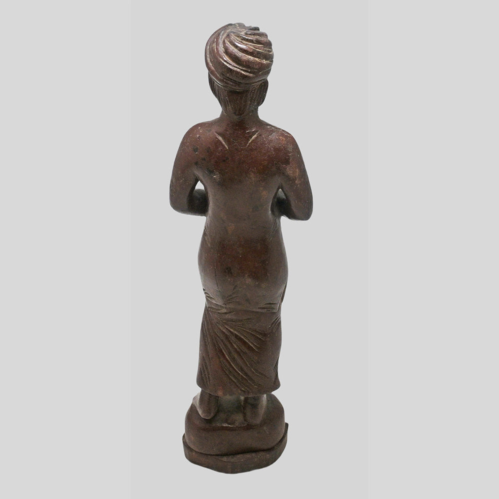 Teak wood musician figurine showing traditional details
