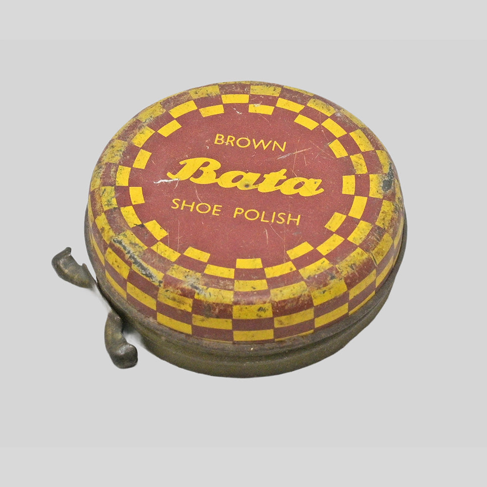 Vintage brown Bata shoe polish printed iron box, angled view