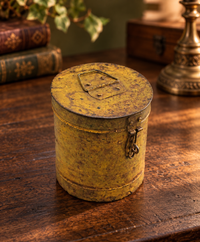 Vintage handcrafted iron storage canister with lid and latch, front view
