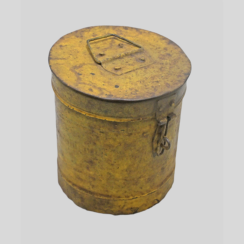 Vintage handcrafted iron storage canister with lid and latch, angled view