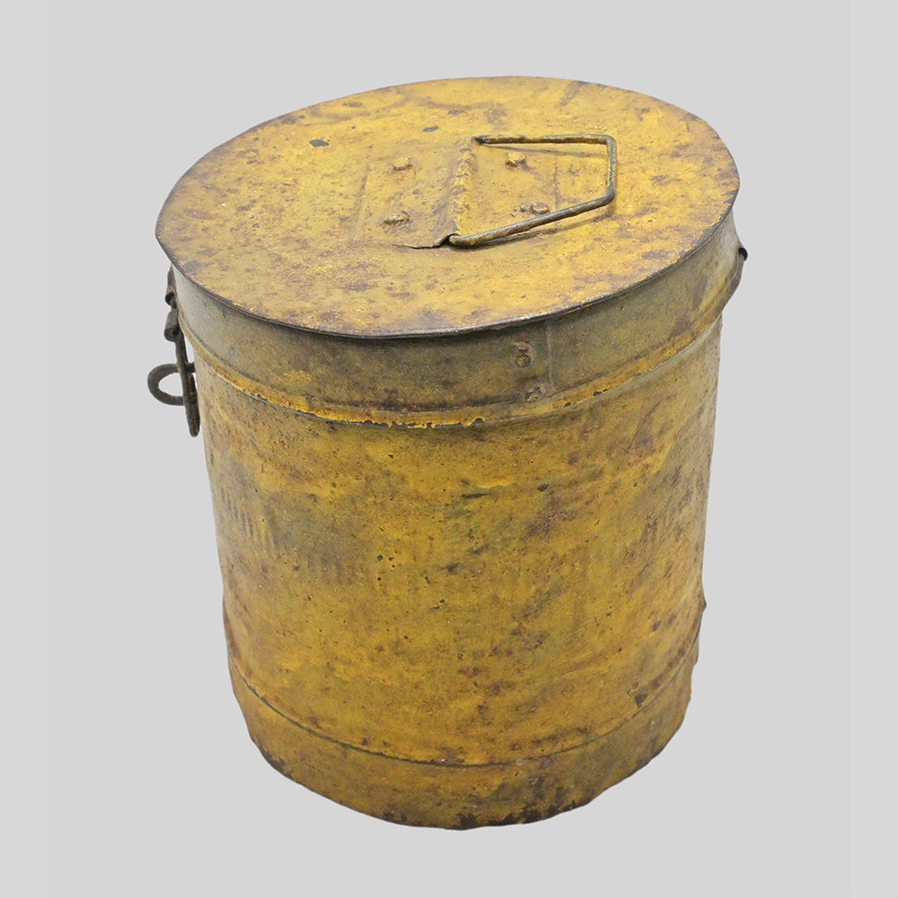 Vintage handcrafted iron storage canister with lid and latch, close-up detail