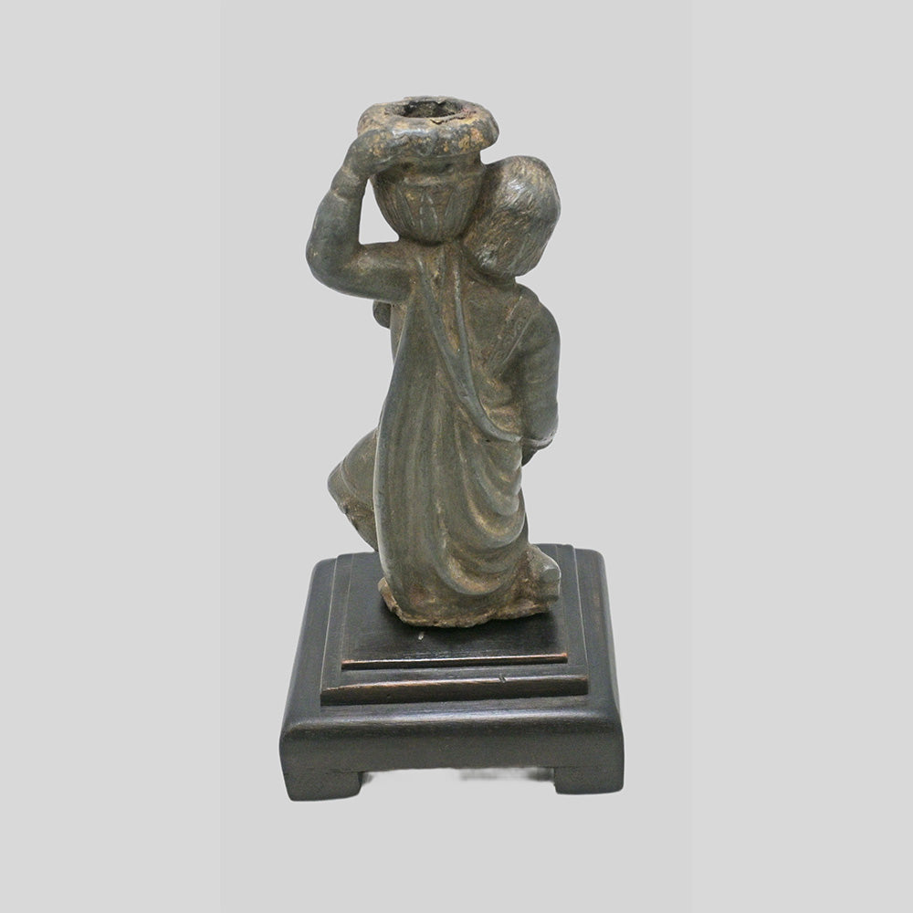 Antique cast metal man figurine carrying a pot, decorative candle holder, alternate view