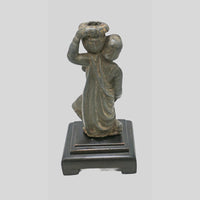 Antique cast metal man figurine carrying a pot, decorative candle holder, alternate view