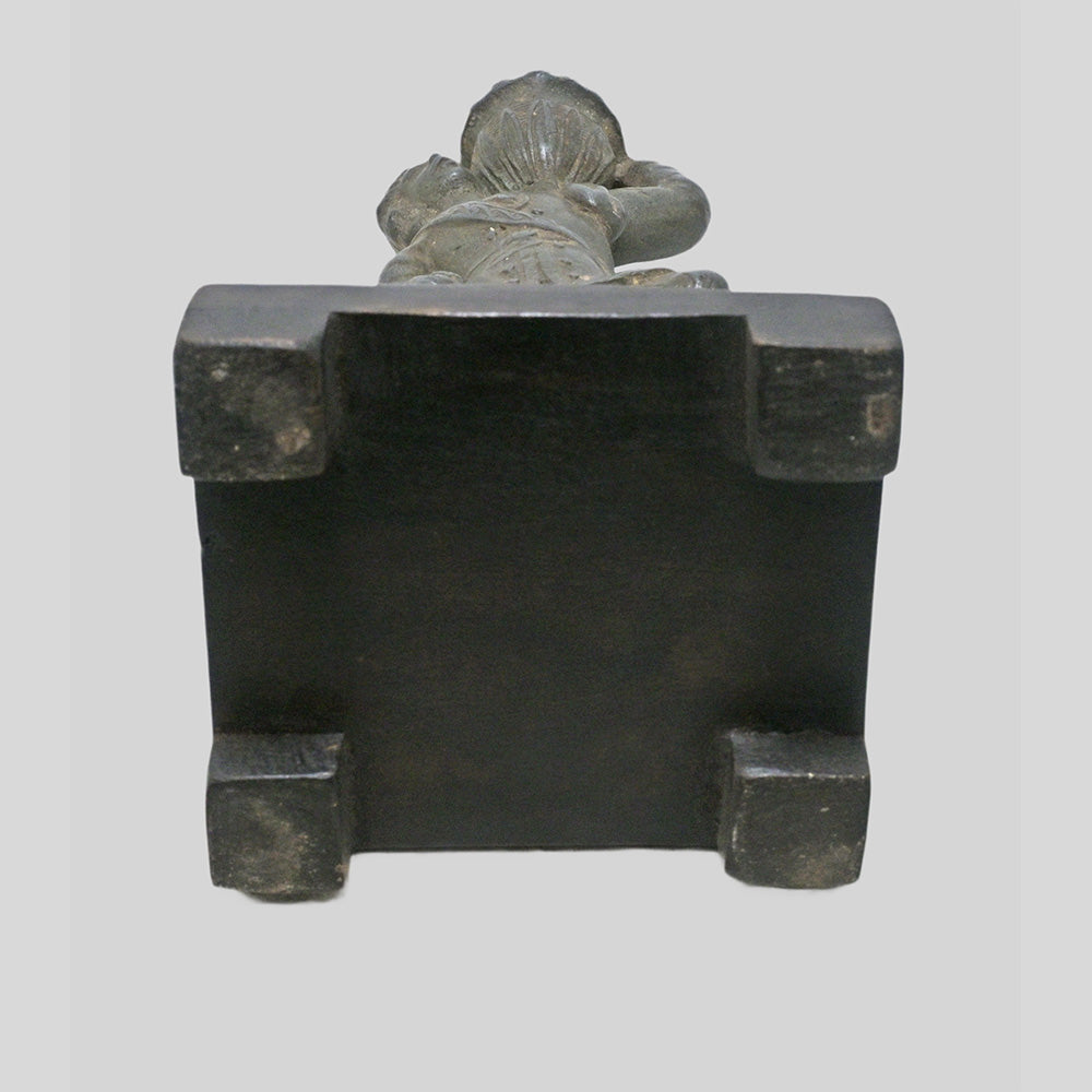 Antique cast metal man figurine carrying a pot, decorative candle holder, additional view