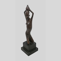 Vintage hand-carved wooden tribal figurine inspired by African art, angled view