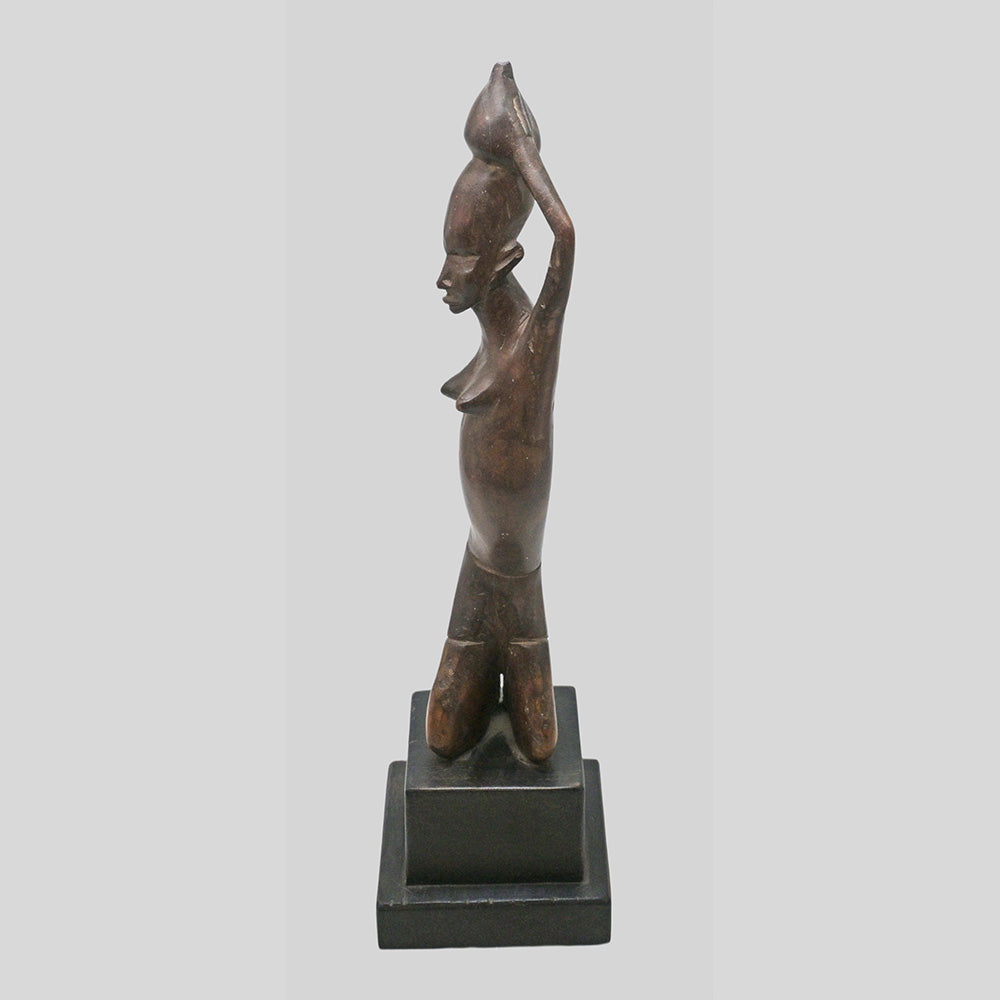 Vintage hand-carved wooden tribal figurine inspired by African art, close-up detail