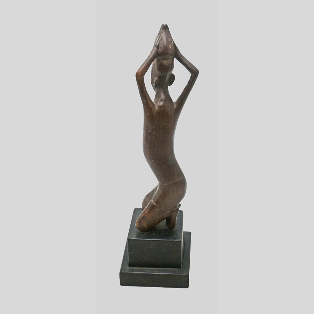 Vintage hand-carved wooden tribal figurine inspired by African art, side view