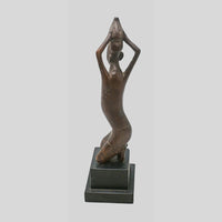 Vintage hand-carved wooden tribal figurine inspired by African art, side view