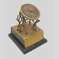 Vintage handcrafted brass figurine with fine artwork detailing, angled view