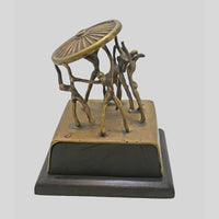 Vintage handcrafted brass figurine with fine artwork detailing, side view