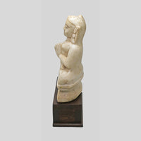 Hand-carved seated Jain Lord Mahavira statue on wooden display base, side view