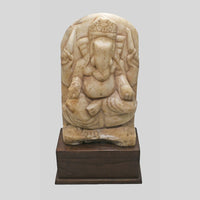 Vintage marble Hindu Lord Ganesha statue on wooden base, close-up detail
