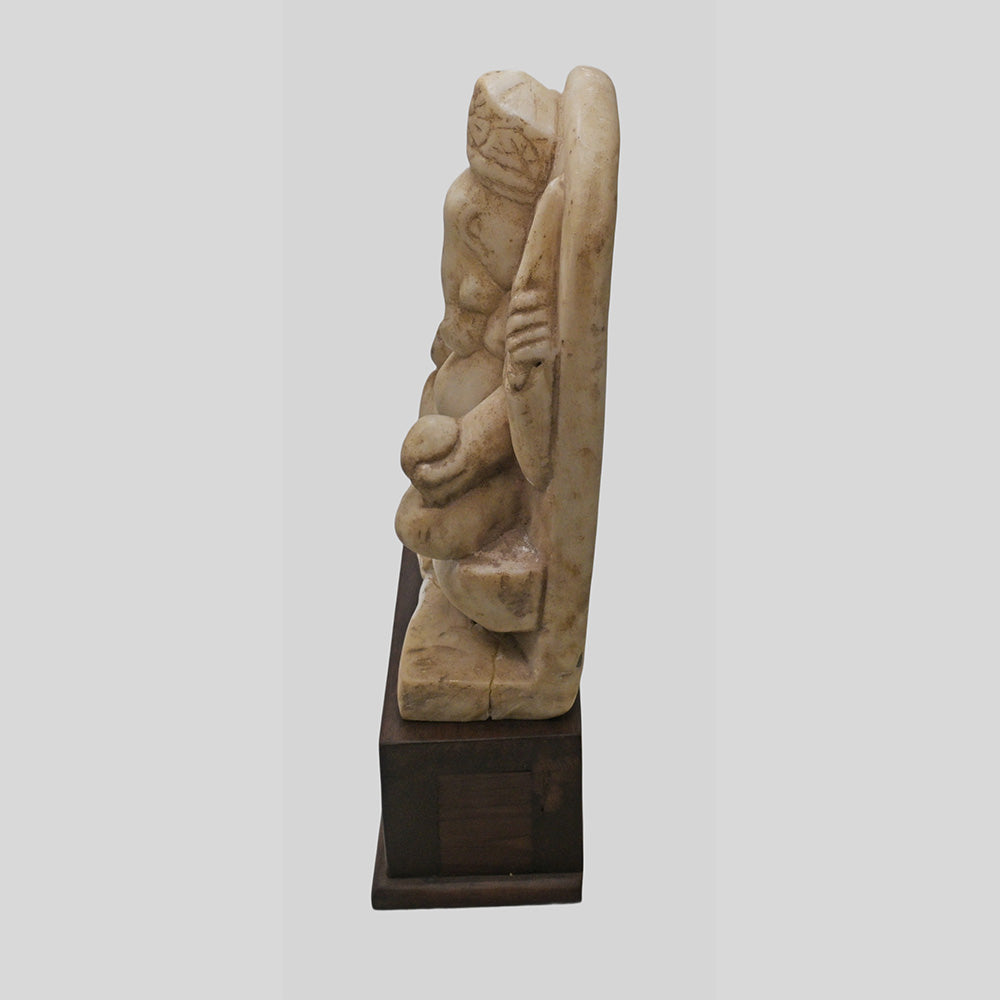 Vintage marble Hindu Lord Ganesha statue on wooden base, side view