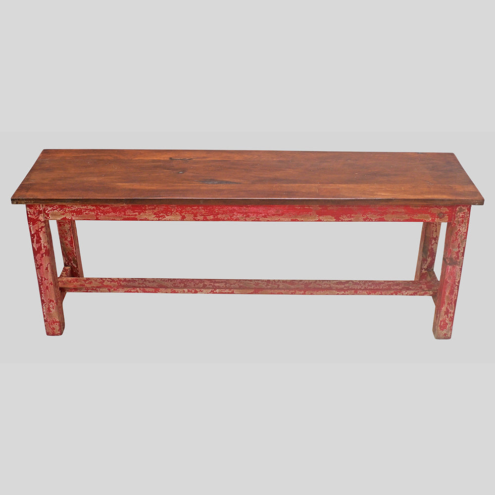 Vintage handcrafted long wooden bench with distressed red finish, close-up detail