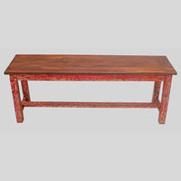Vintage handcrafted long wooden bench with distressed red finish, close-up detail